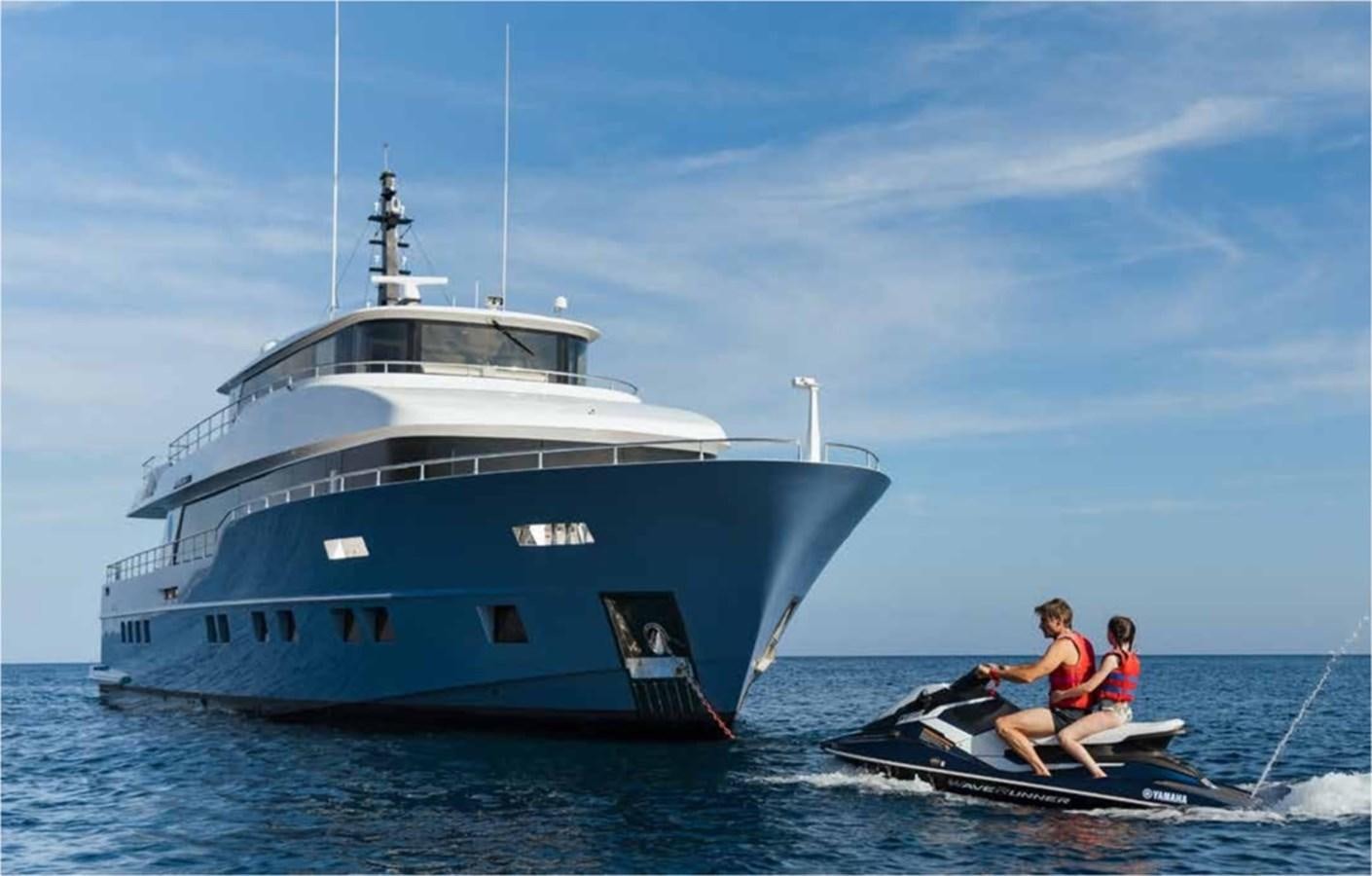 a couple of kids on a boat in the water aboard NOMAD 95 SUV Yacht for Sale