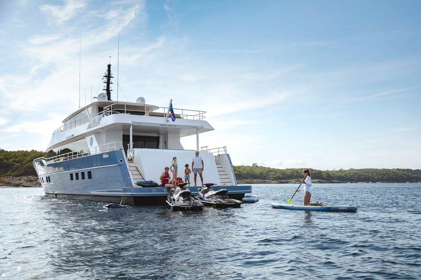 a boat with people on it aboard NOMAD 95 SUV Yacht for Sale