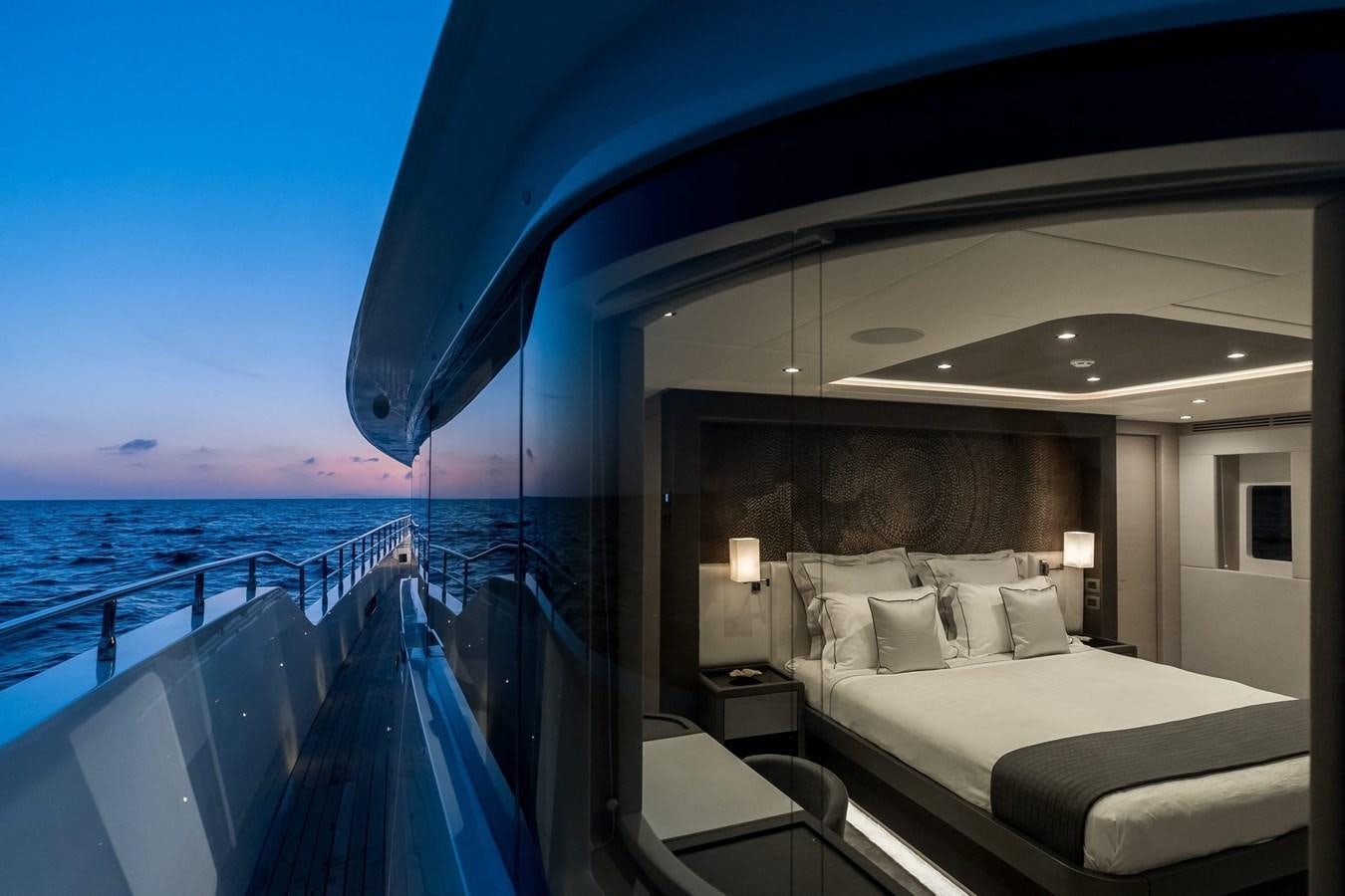 a room with a bed and a view of the ocean aboard NOMAD 95 SUV Yacht for Sale