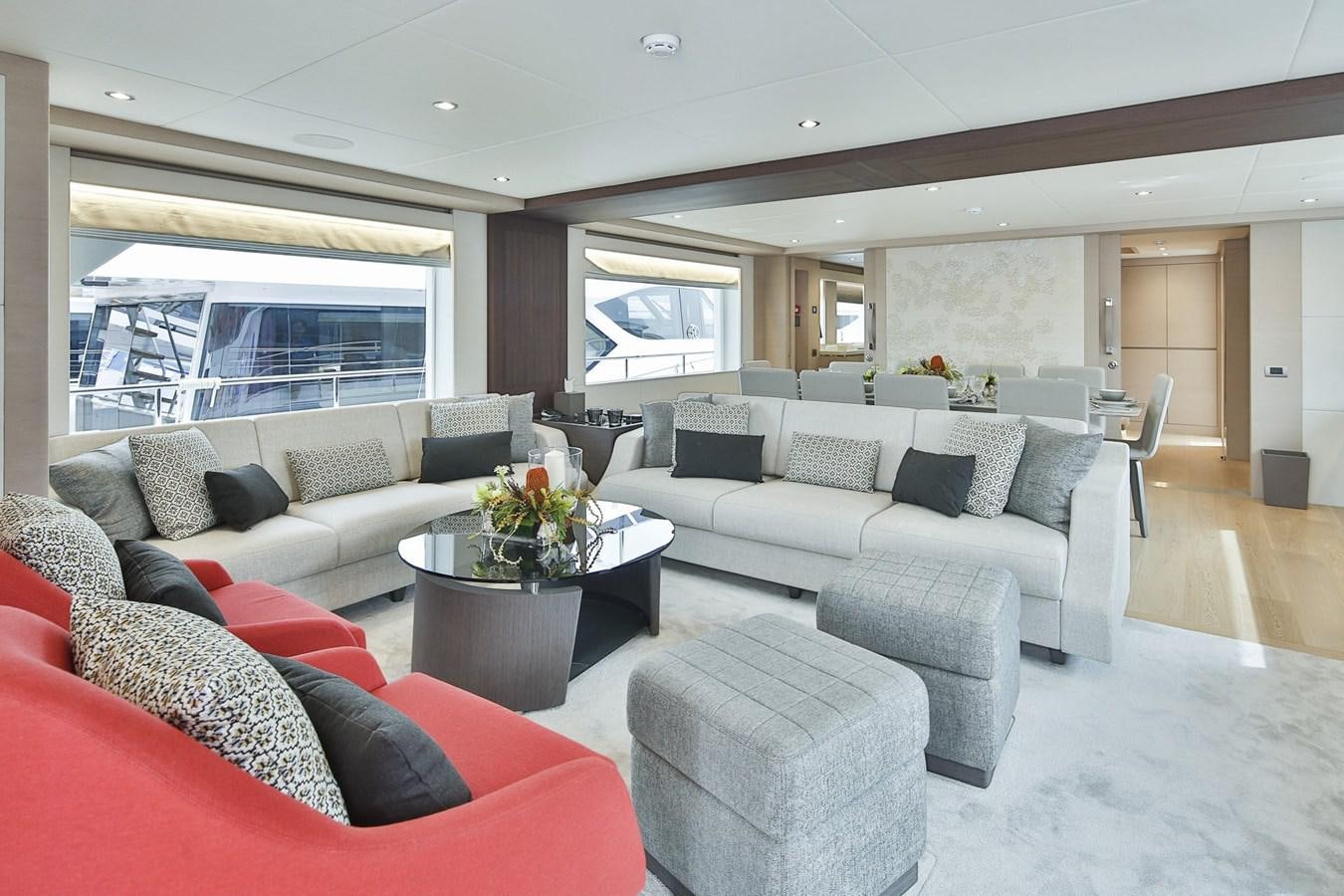 a living room with a couch and a table aboard NOMAD 95 SUV Yacht for Sale