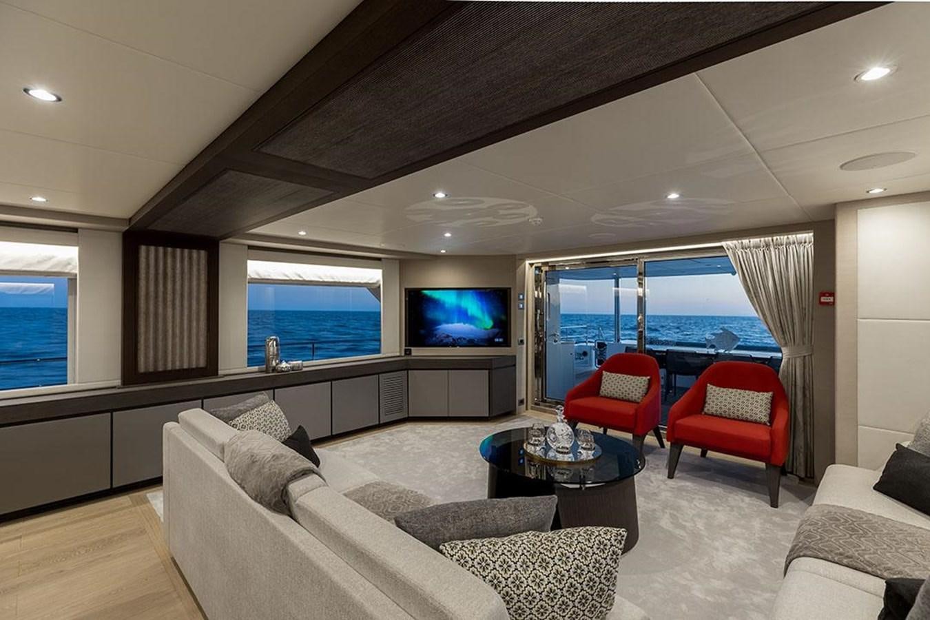 a living room with a large window aboard NOMAD 95 SUV Yacht for Sale