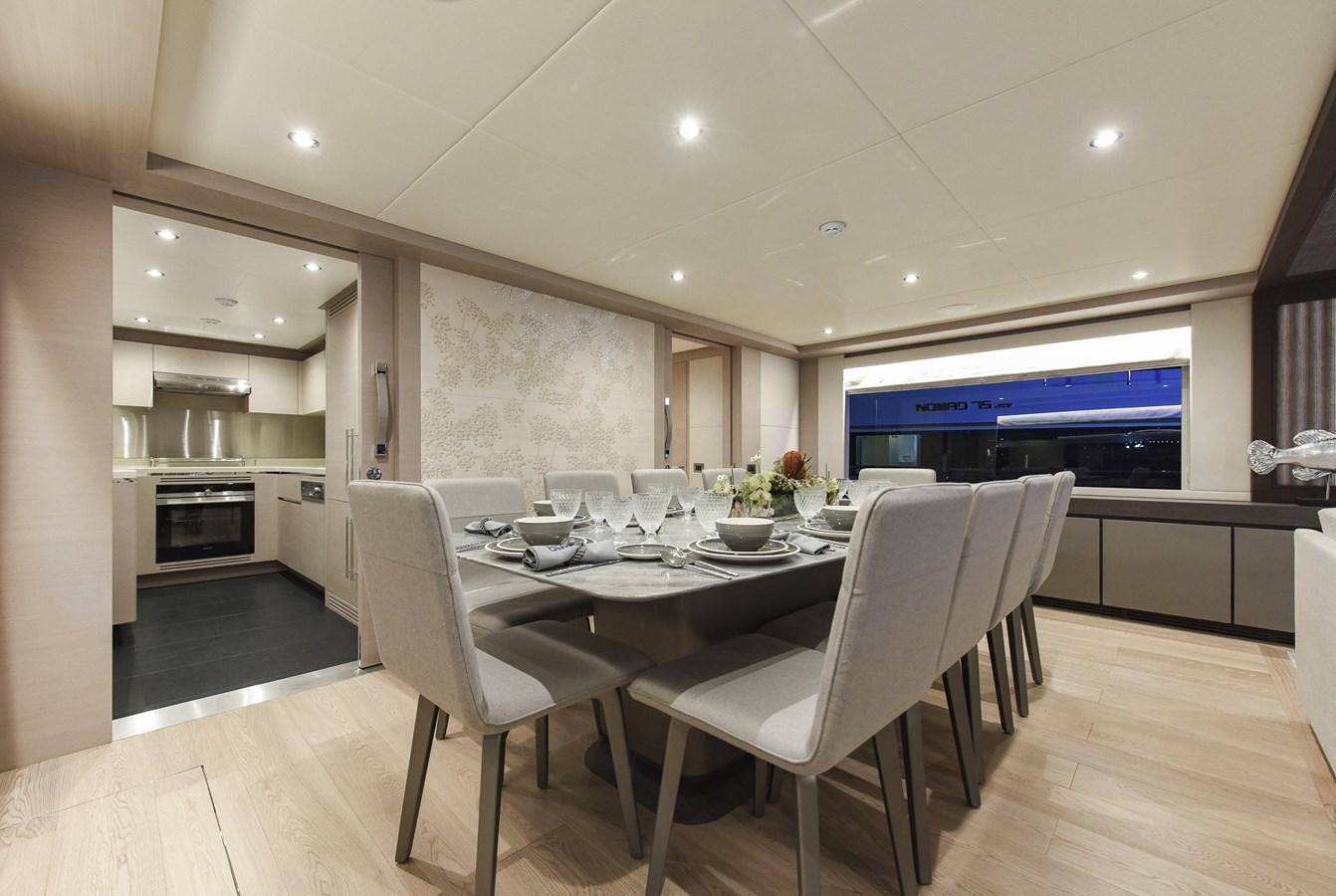 a large dining table in a room aboard NOMAD 95 SUV Yacht for Sale