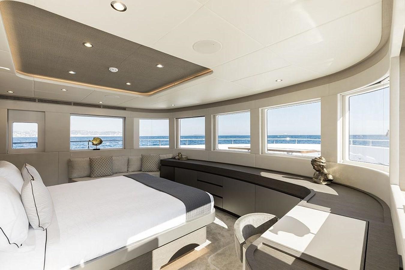 a room with a bed and a desk aboard NOMAD 95 SUV Yacht for Sale