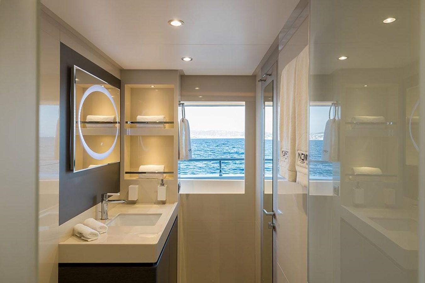 a bathroom with a large mirror aboard NOMAD 95 SUV Yacht for Sale