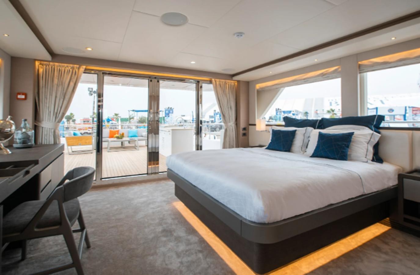 a large bedroom with a large bed aboard NOMAD 95 SUV Yacht for Sale