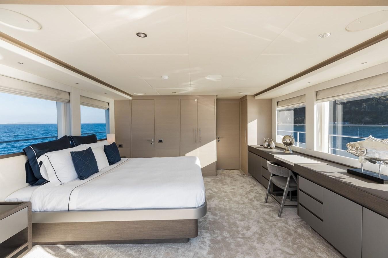 a bedroom with a large bed aboard NOMAD 95 SUV Yacht for Sale