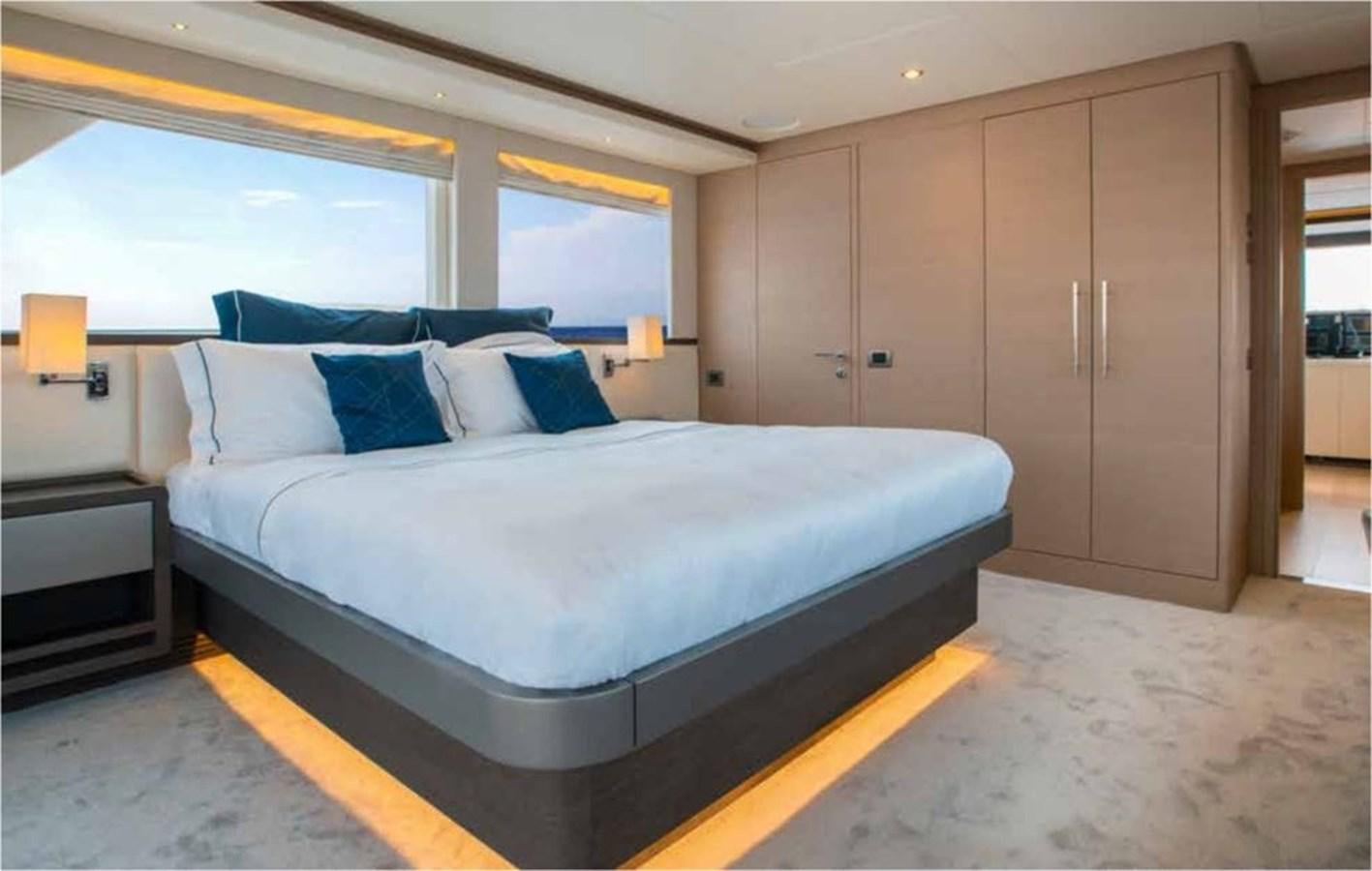 a bed in a room aboard NOMAD 95 SUV Yacht for Sale