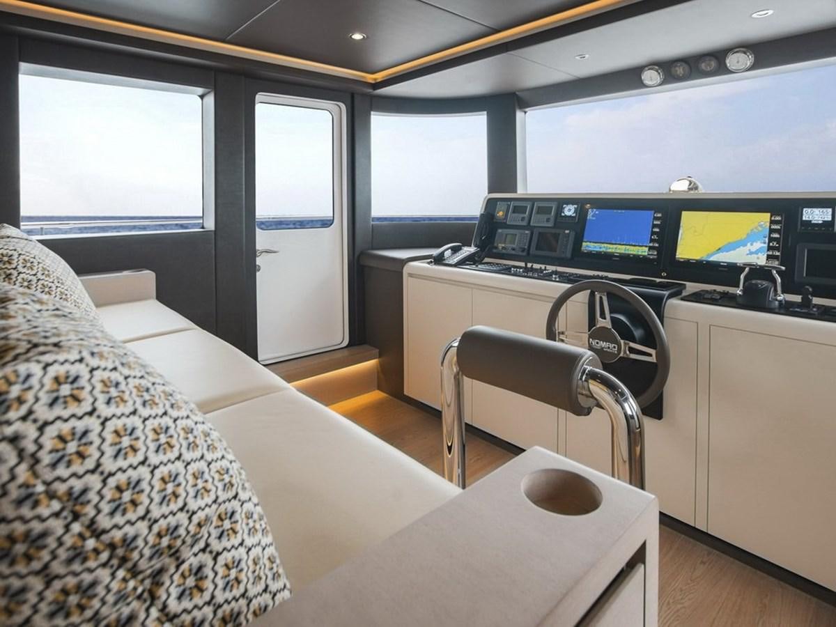 a room with a bed and a desk with a computer aboard NOMAD 95 SUV Yacht for Sale