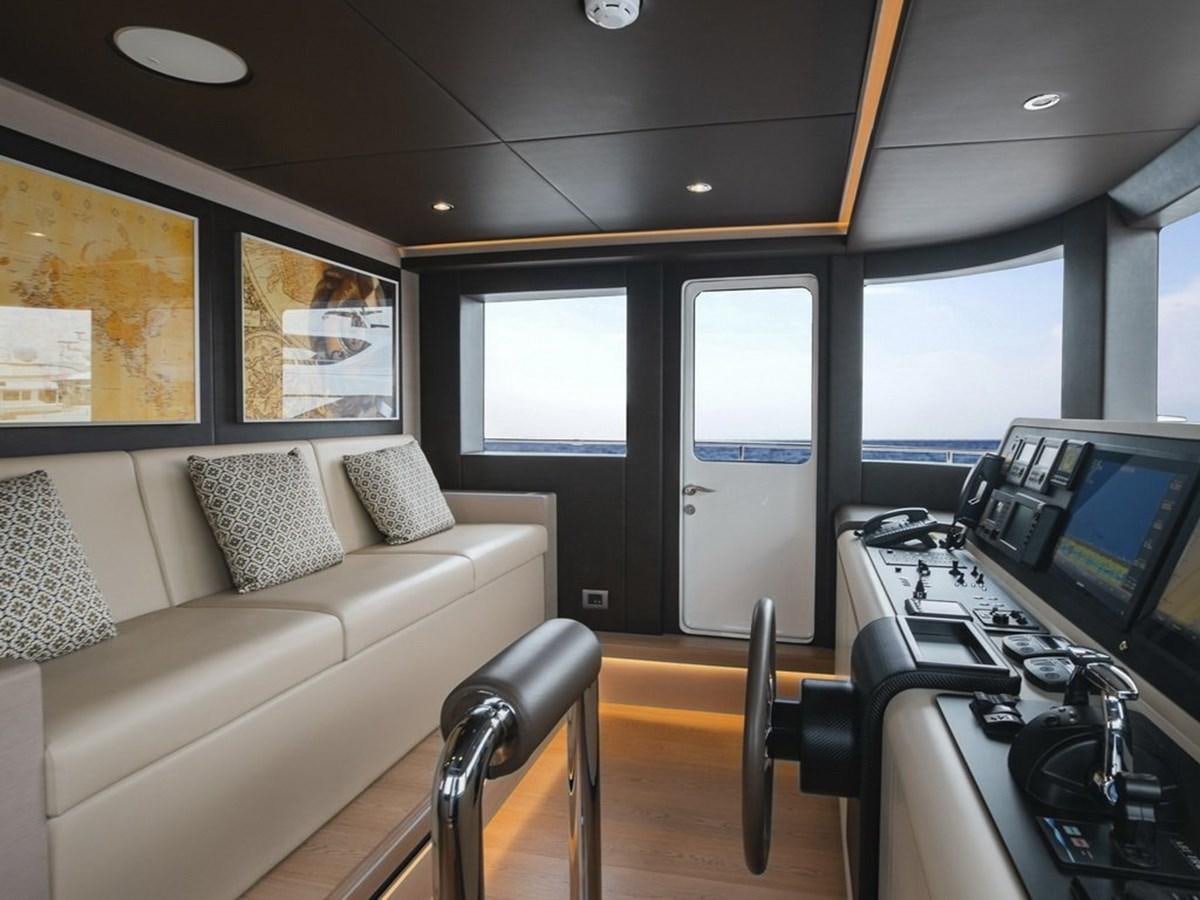 a room with a couch and a computer aboard NOMAD 95 SUV Yacht for Sale