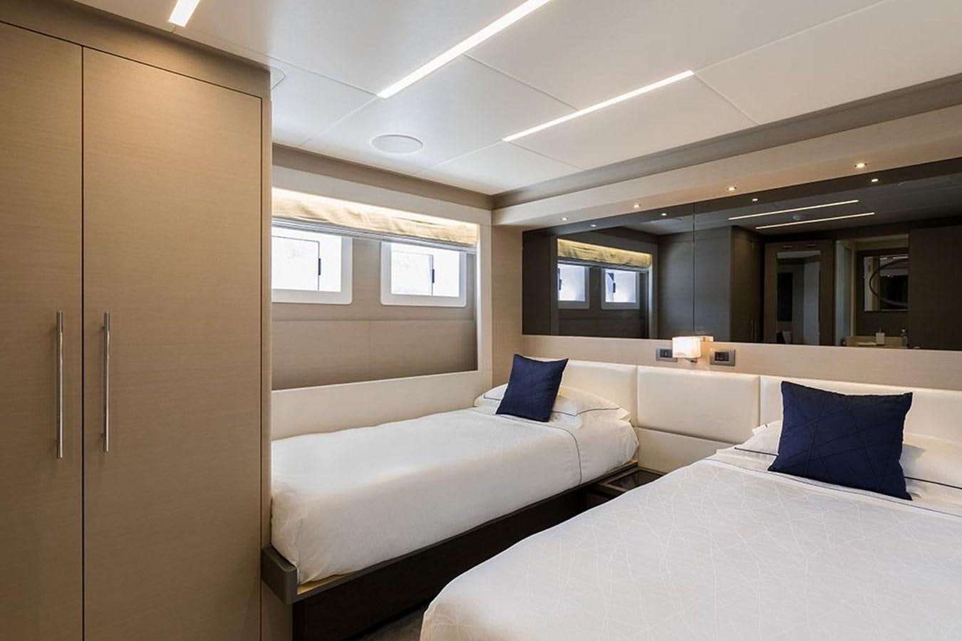 a room with two beds aboard NOMAD 95 SUV Yacht for Sale