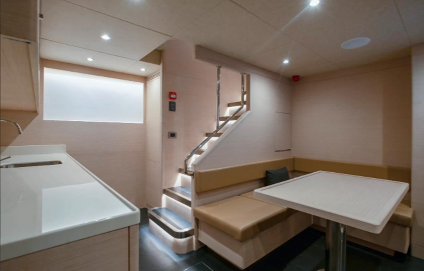 a white kitchen with a white counter aboard NOMAD 95 SUV Yacht for Sale