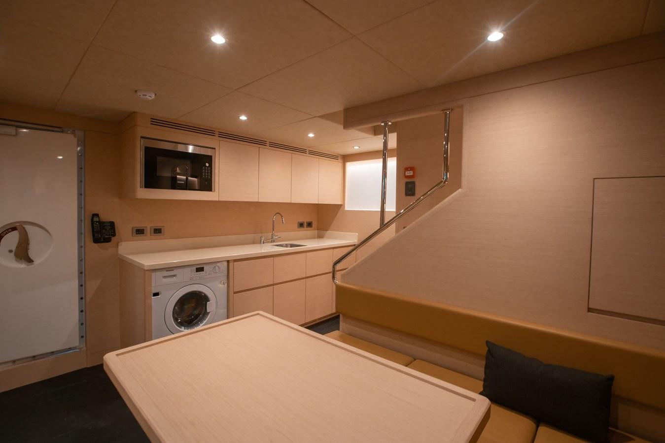 a kitchen with white cabinets aboard NOMAD 95 SUV Yacht for Sale