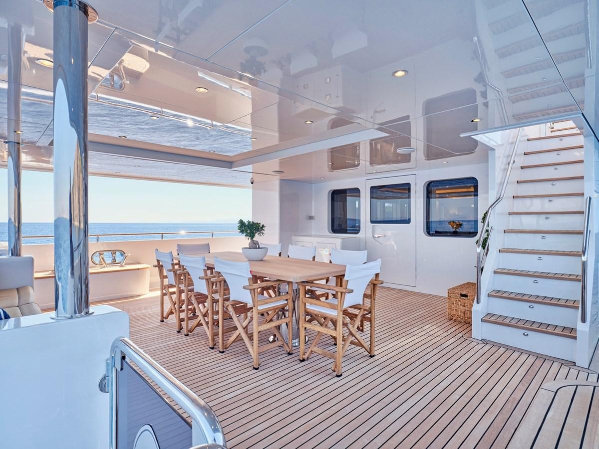 a room with a table and chairs aboard 3D Yacht for Sale