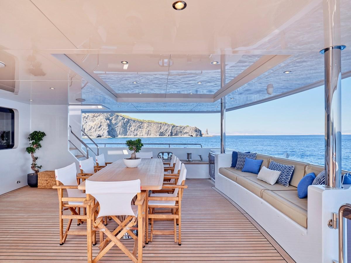 a large living room with a large balcony overlooking the ocean aboard 3D Yacht for Sale