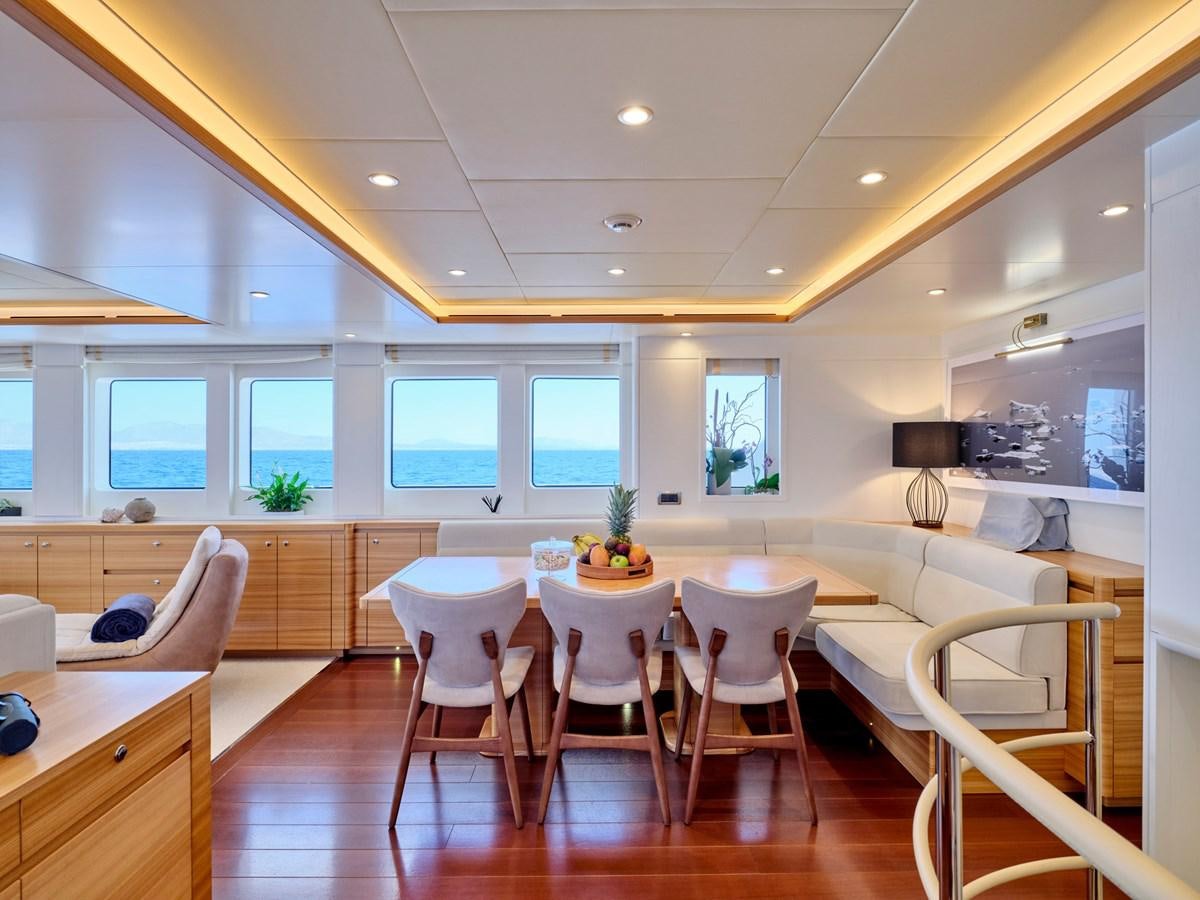 a large kitchen with a dining table aboard 3D Yacht for Sale