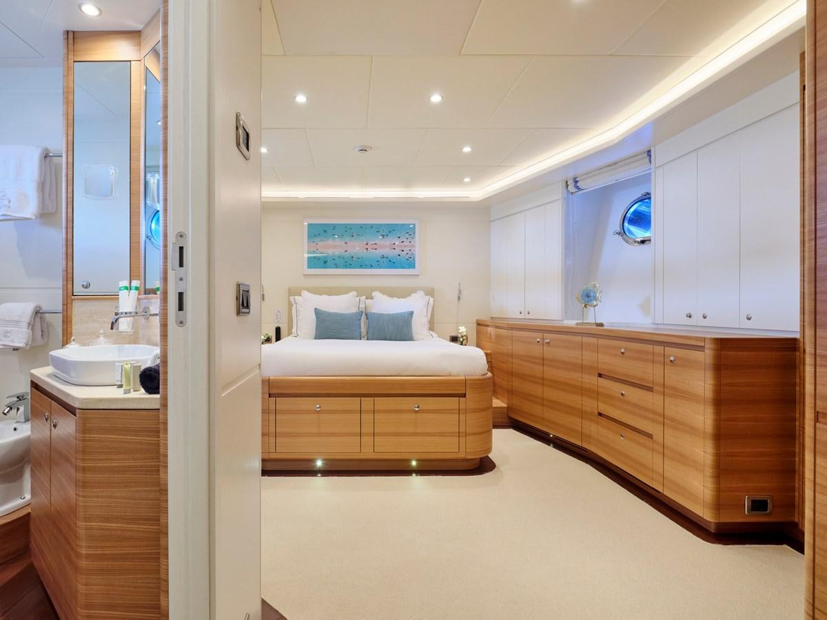 a bedroom with a bed and a dresser aboard 3D Yacht for Sale