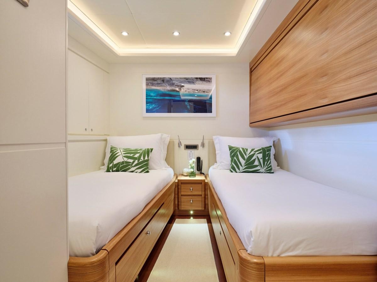 a room with two beds aboard 3D Yacht for Sale