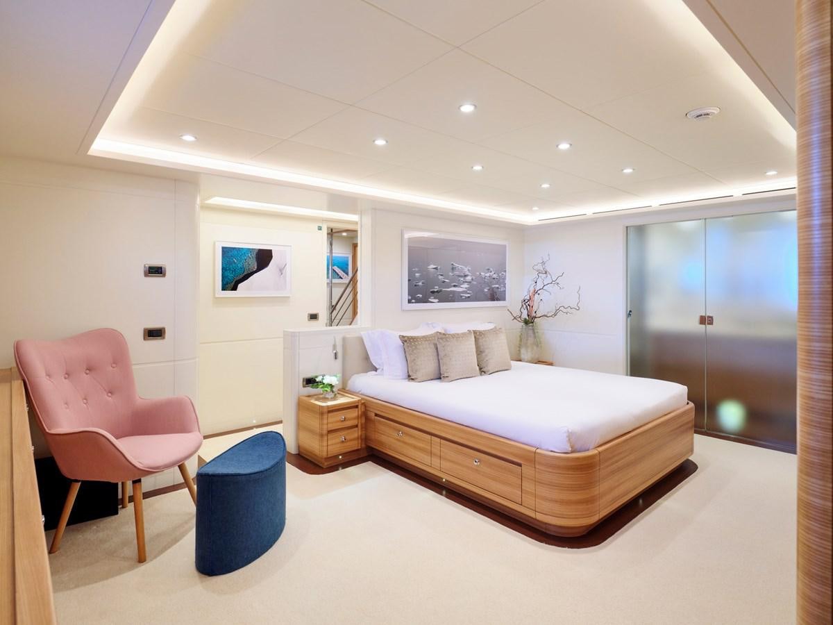 a bedroom with a bed and a chair aboard 3D Yacht for Sale