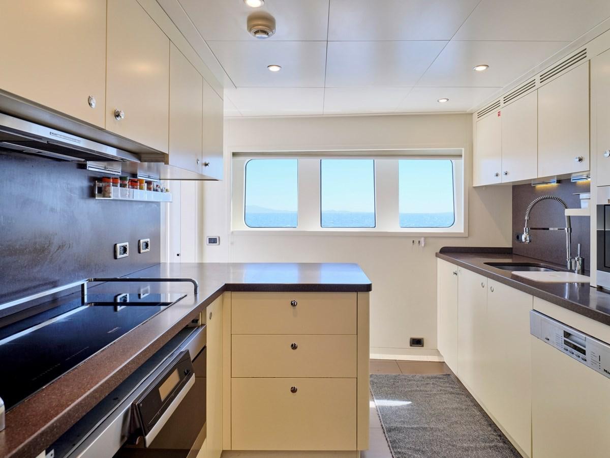 a kitchen with white cabinets aboard 3D Yacht for Sale