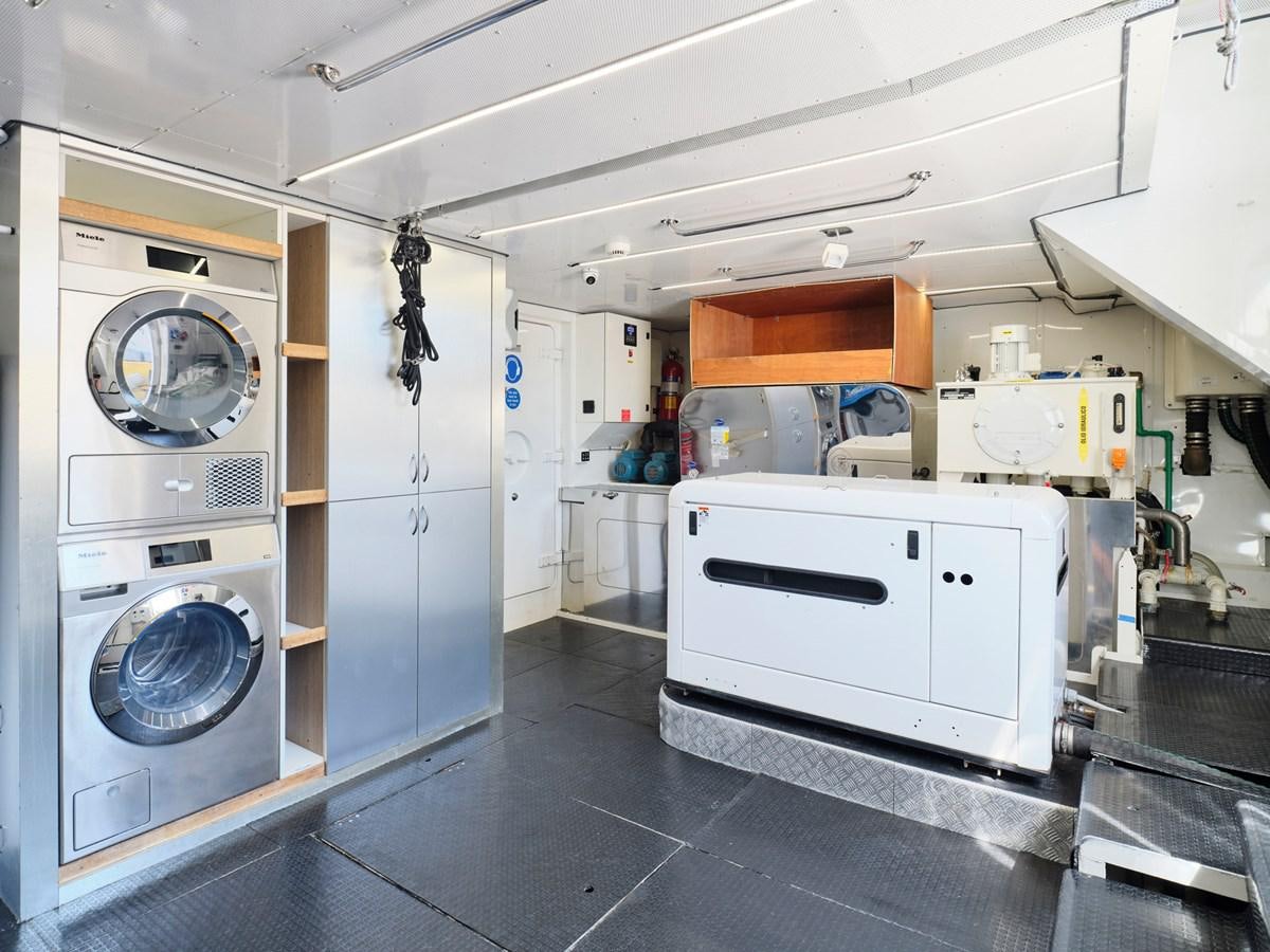 a large room with white cabinets aboard 3D Yacht for Sale