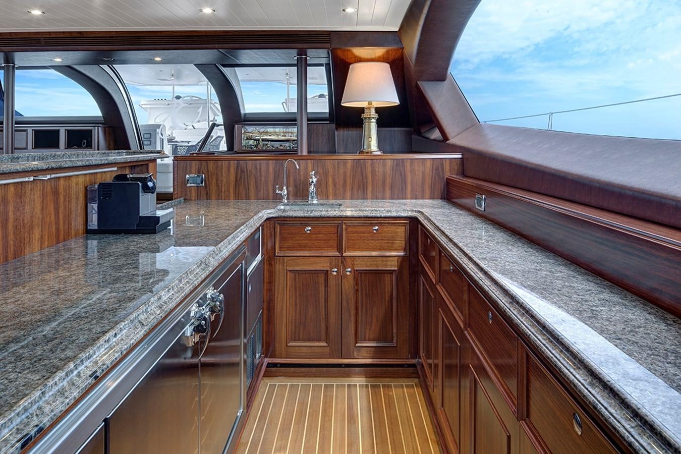 a large wooden room with a large window and a large wood table aboard ENCORE Yacht for Sale