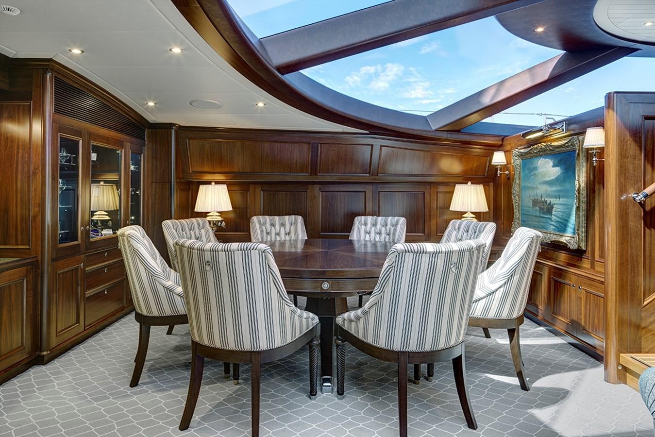 a dining room with a table and chairs aboard ENCORE Yacht for Sale