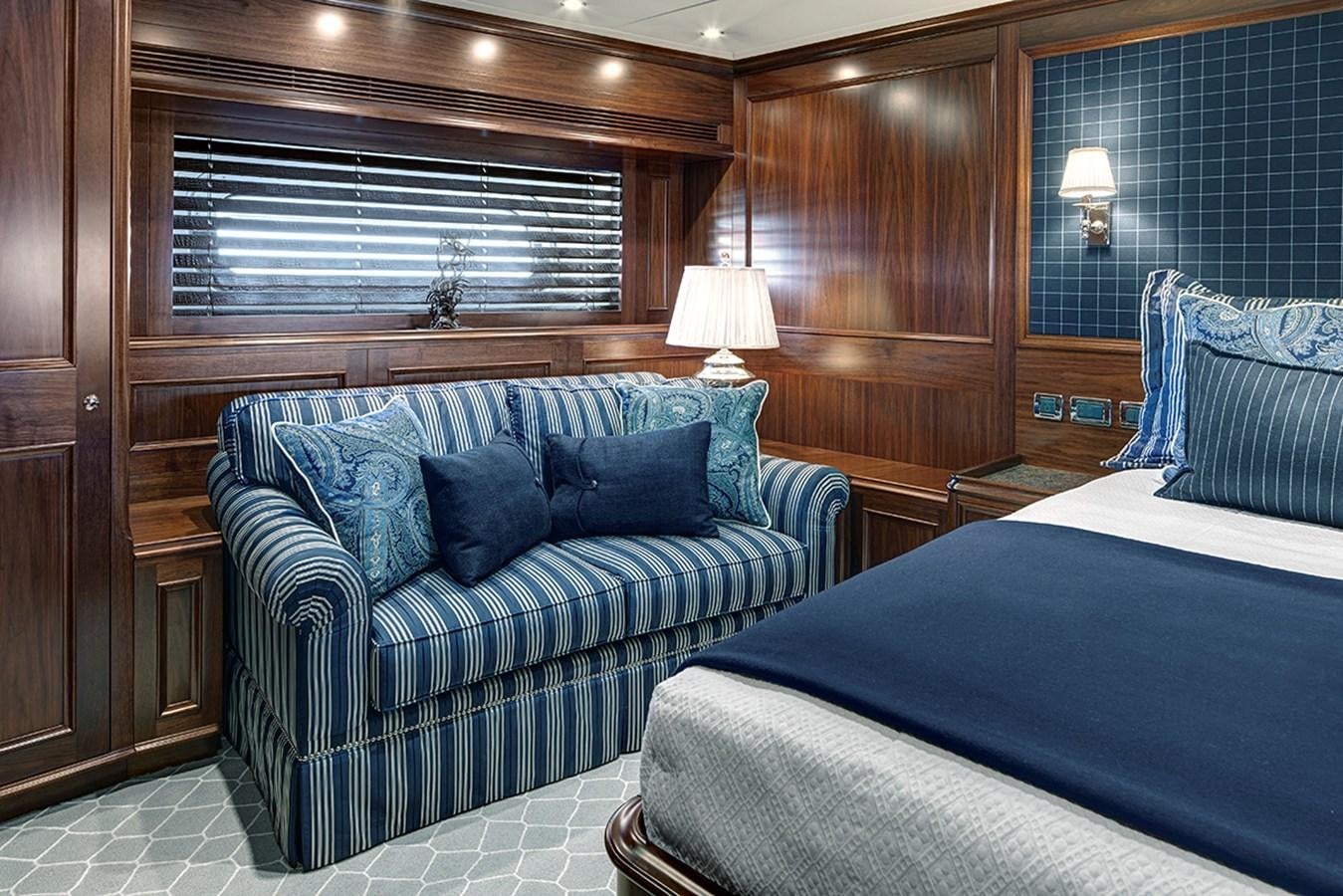 a room with a bed and a couch aboard ENCORE Yacht for Sale