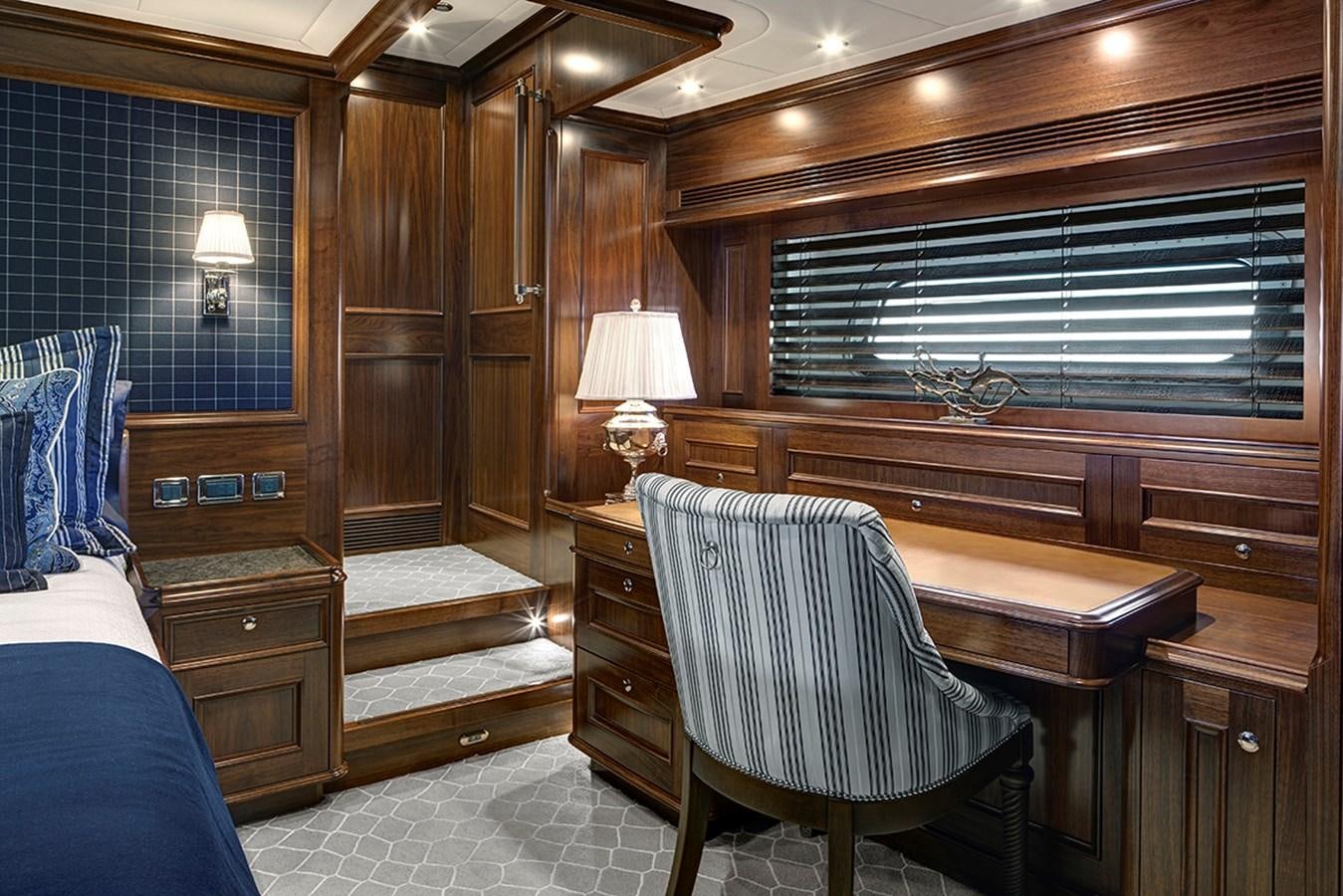 a room with a bed and a desk aboard ENCORE Yacht for Sale