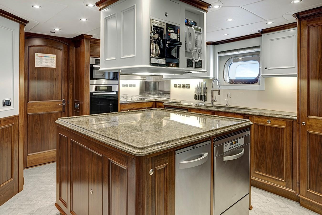 a kitchen with a marble counter top aboard ENCORE Yacht for Sale