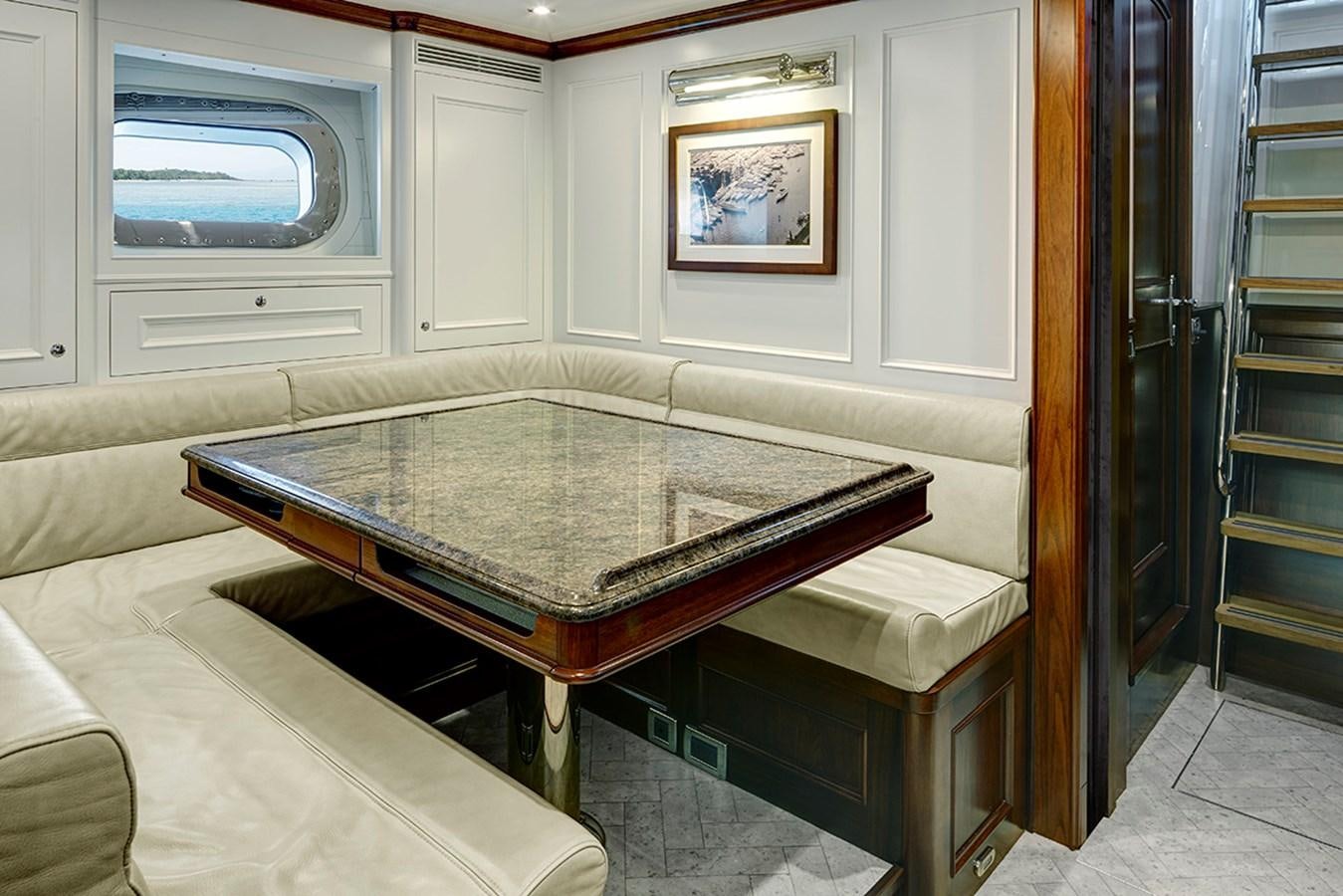 a living room with a table and tv aboard ENCORE Yacht for Sale