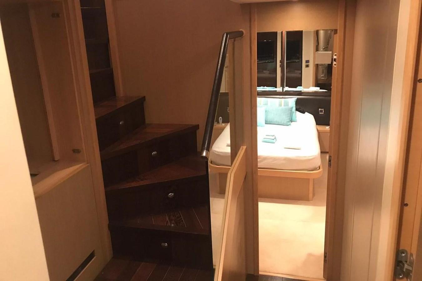 a room with a bed and a desk aboard PRINCESS I Yacht for Sale
