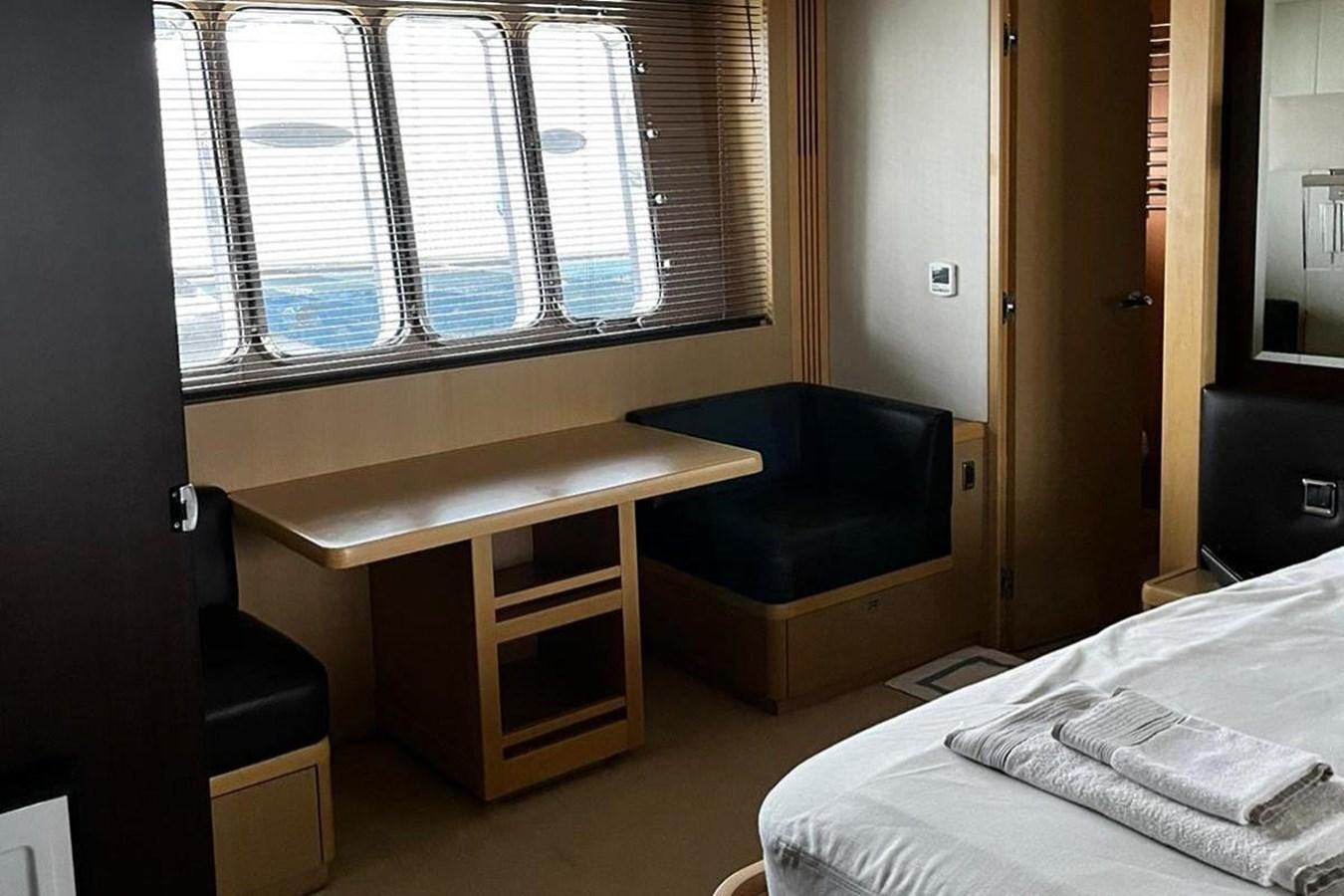 a bed and desk in a room aboard PRINCESS I Yacht for Sale