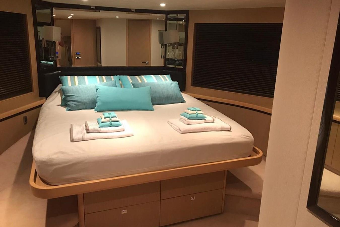 a bed with blue pillows aboard PRINCESS I Yacht for Sale