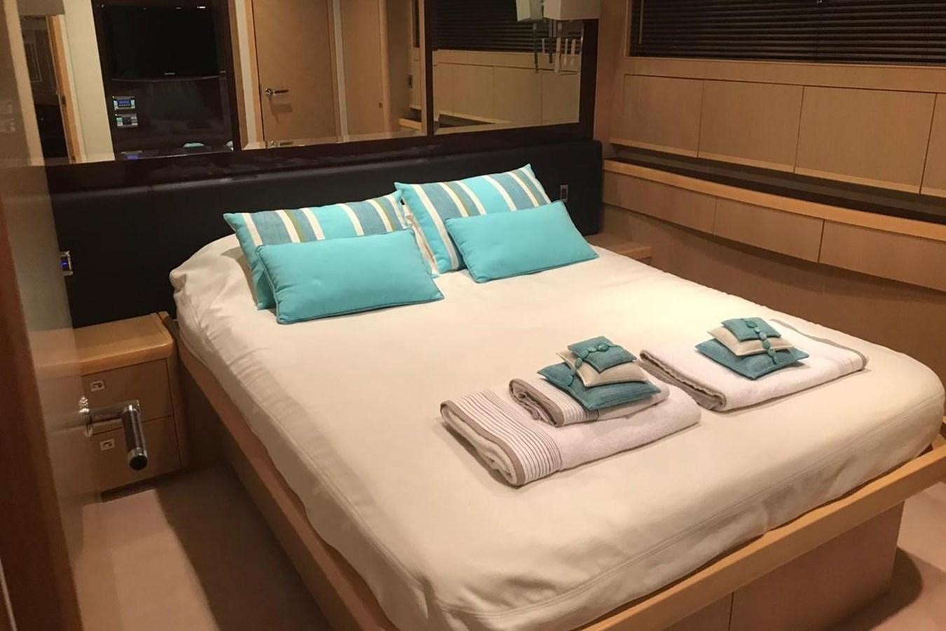 a bed with blue pillows aboard PRINCESS I Yacht for Sale