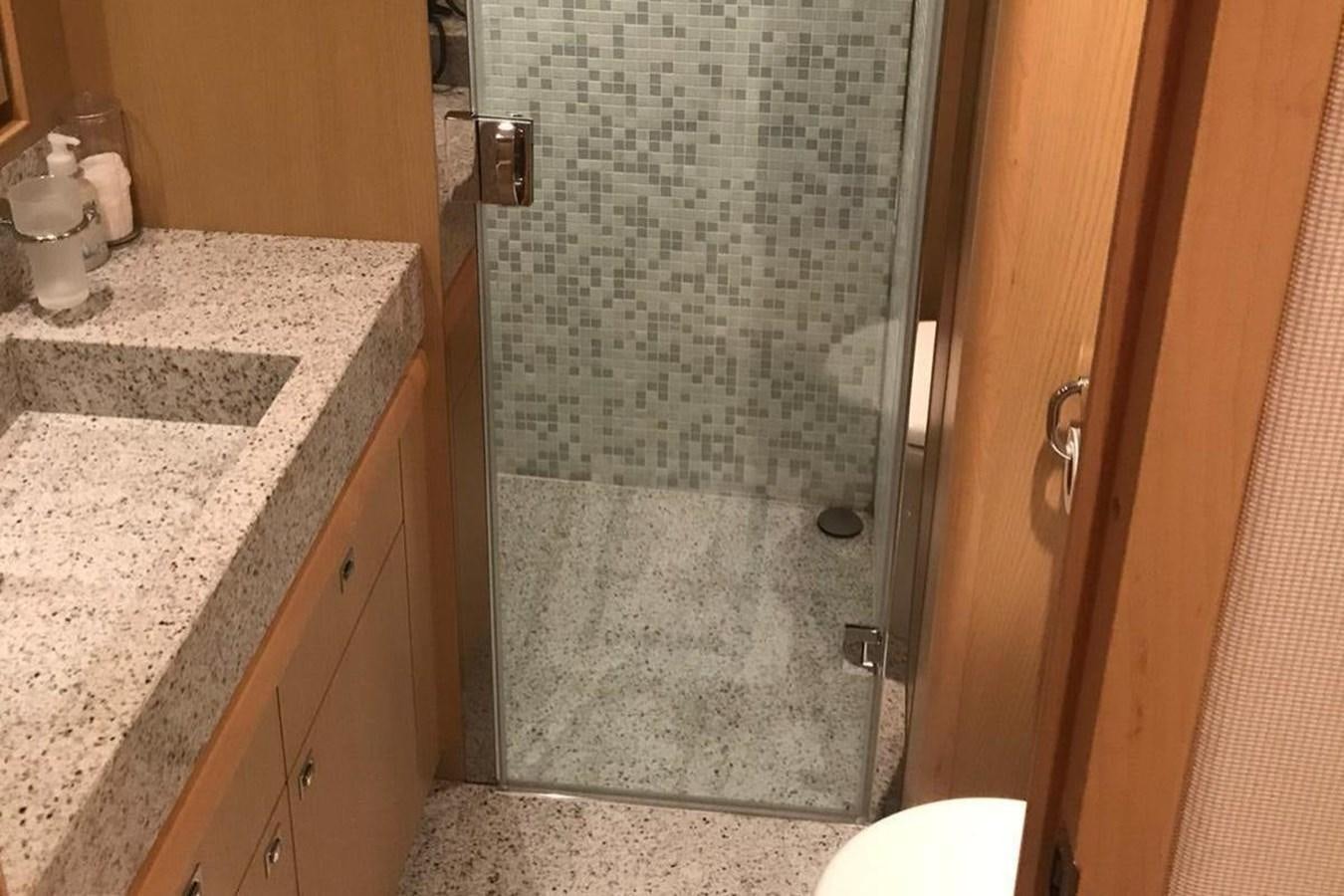 a bathroom with a glass shower aboard PRINCESS I Yacht for Sale