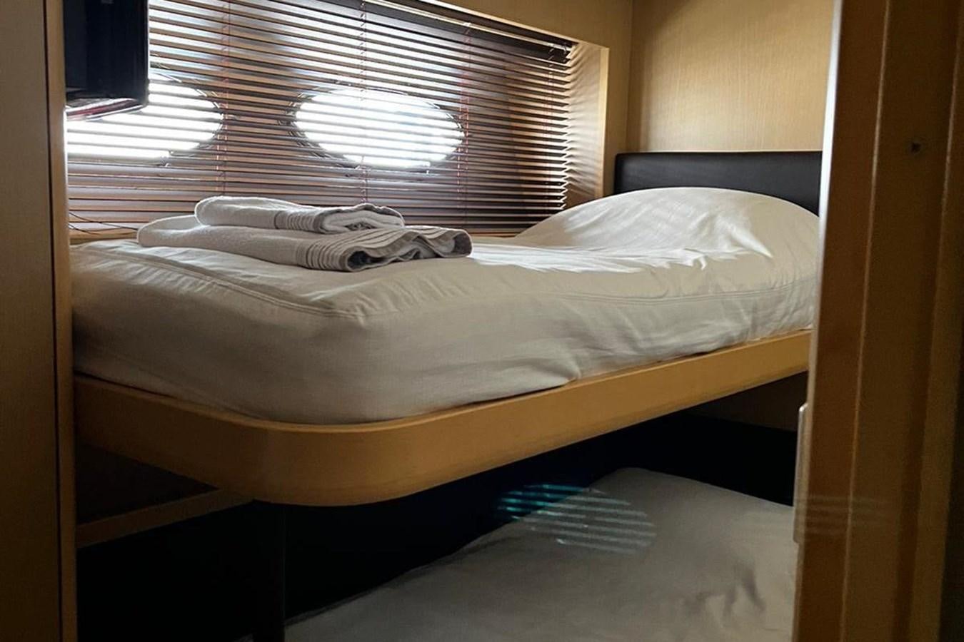 a bed with a white sheet and a white pillow aboard PRINCESS I Yacht for Sale