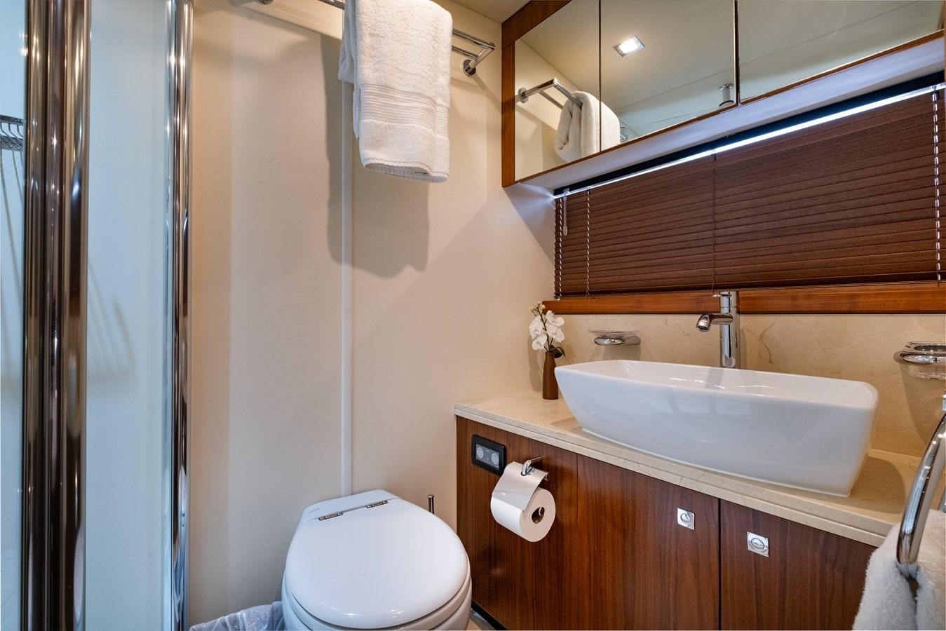 a bathroom with a sink toilet and a mirror aboard EL TIO Yacht for Sale