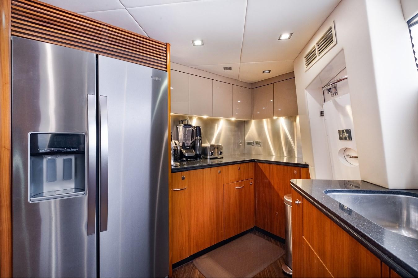a kitchen with a refrigerator and sink aboard EL TIO Yacht for Sale