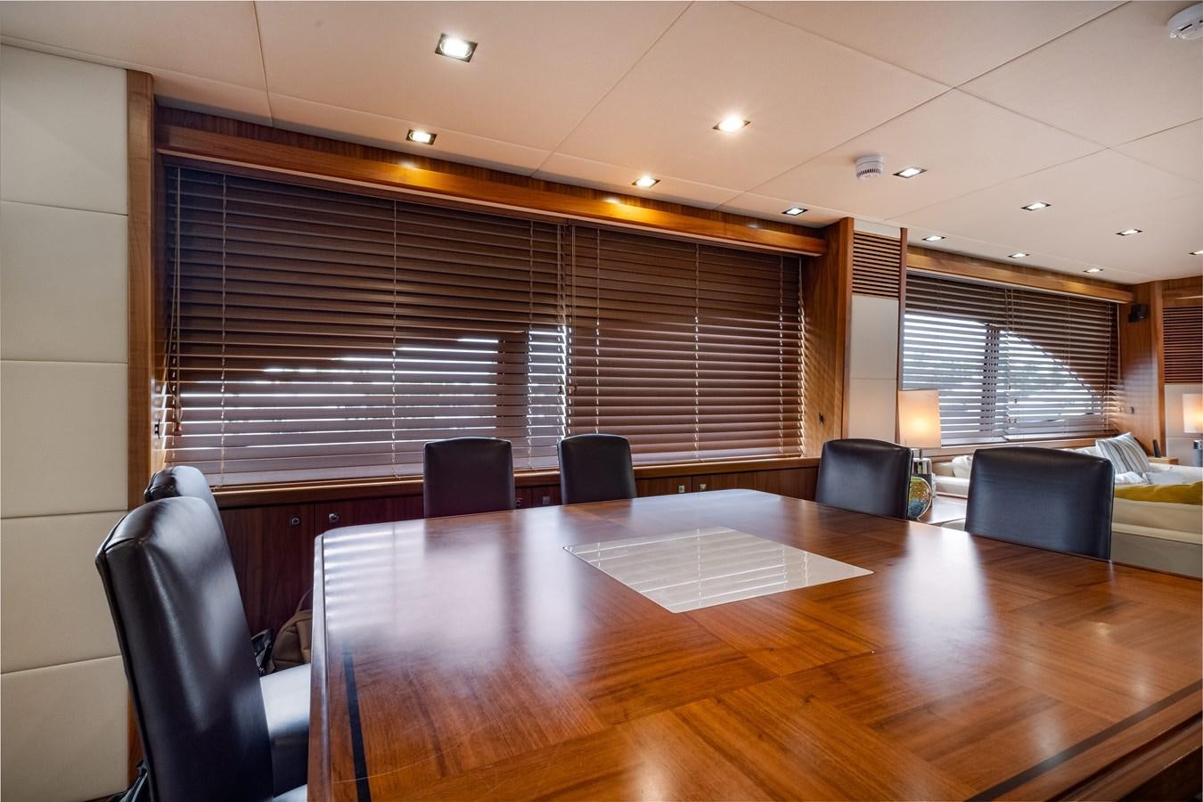 a conference room with a table and chairs aboard EL TIO Yacht for Sale