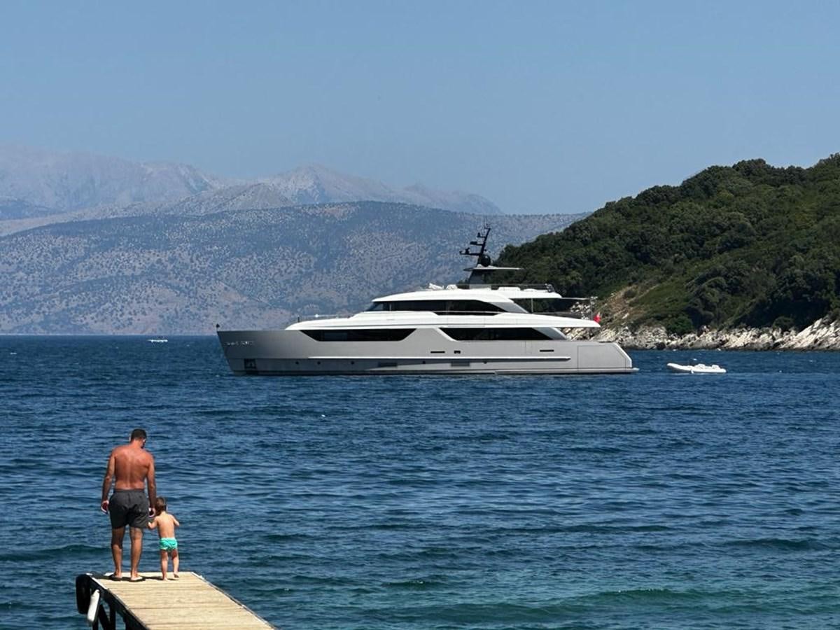 a man and a child standing on a dock by a boat aboard SANLORENZO SD118 #101 Yacht for Sale