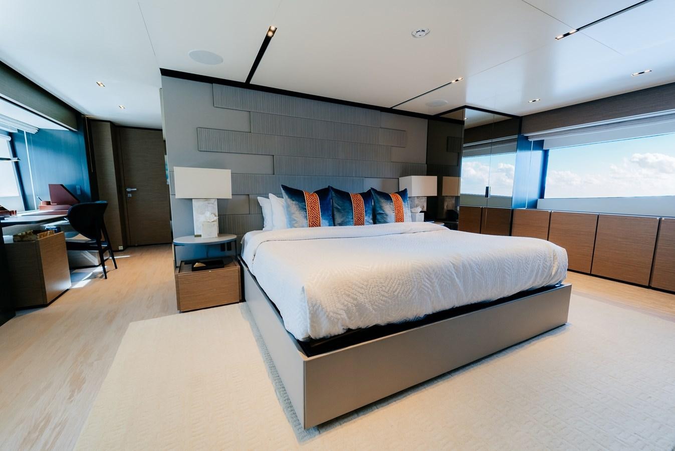 a room with a bed and a desk aboard COFINA Yacht for Sale
