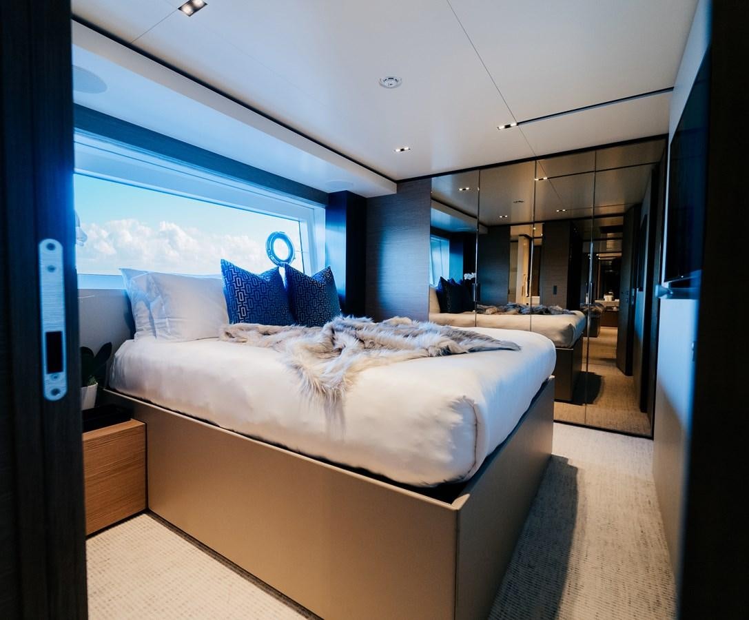 a room with a bed and a window aboard COFINA Yacht for Sale