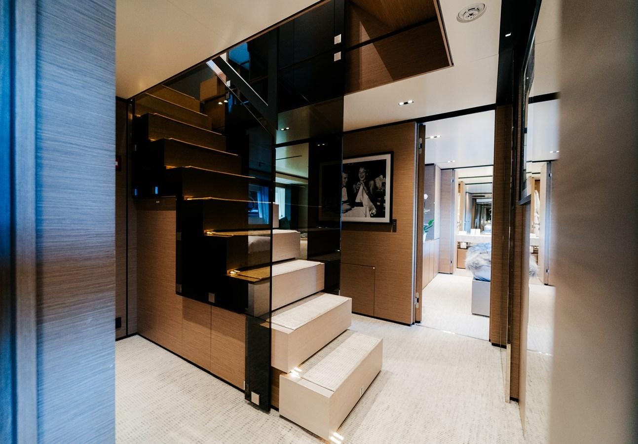 a room with a staircase and a large window aboard COFINA Yacht for Sale