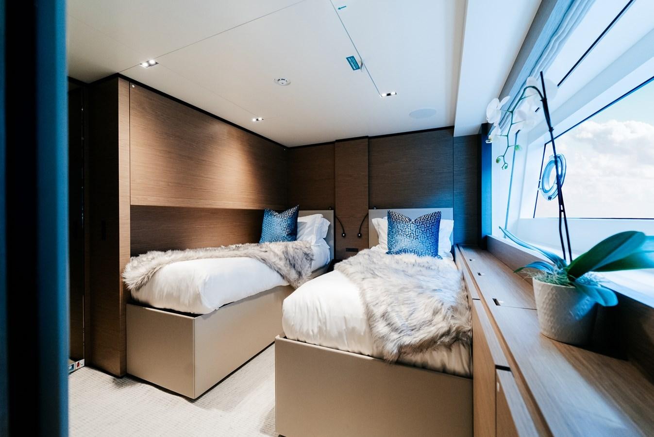 a room with two beds aboard COFINA Yacht for Sale