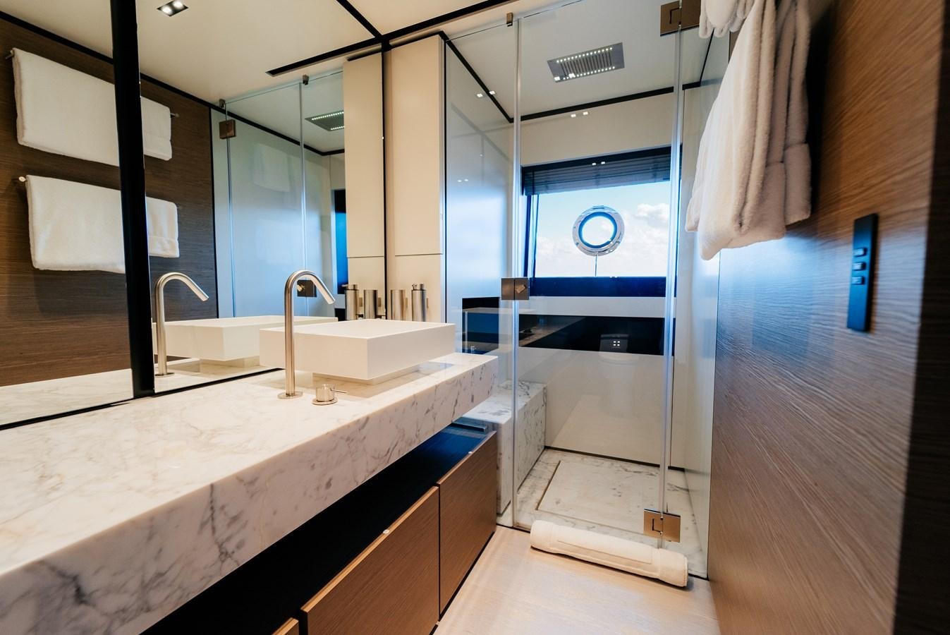 a bathroom with a countertop sink and mirror aboard COFINA Yacht for Sale