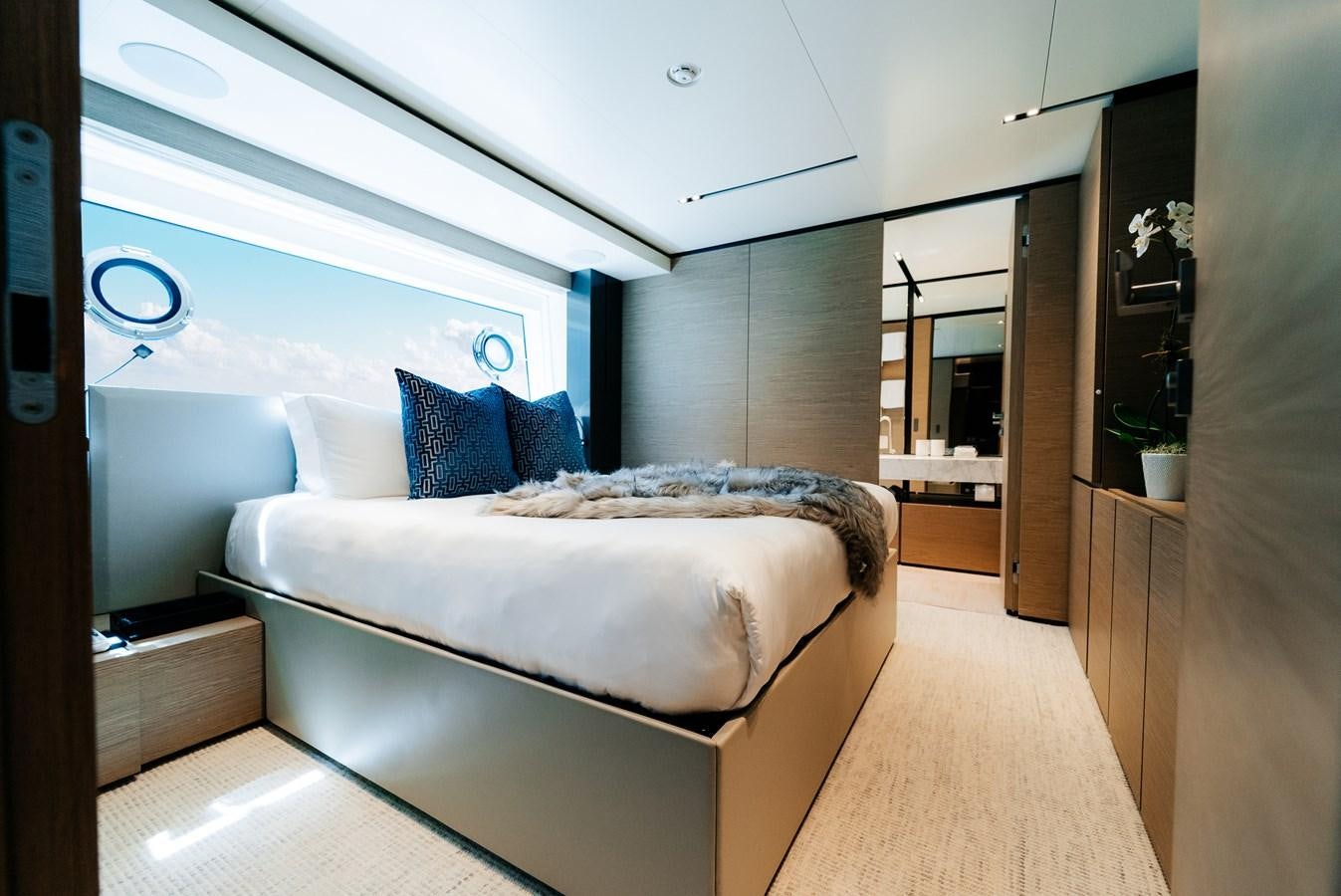 a room with a bed and a mirror aboard COFINA Yacht for Sale
