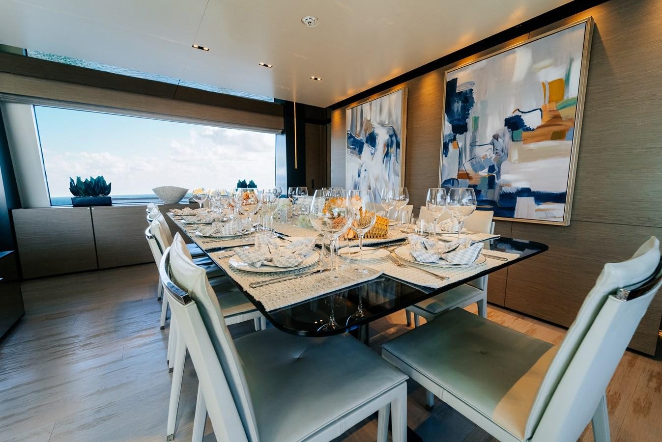 a dining table with chairs aboard COFINA Yacht for Sale