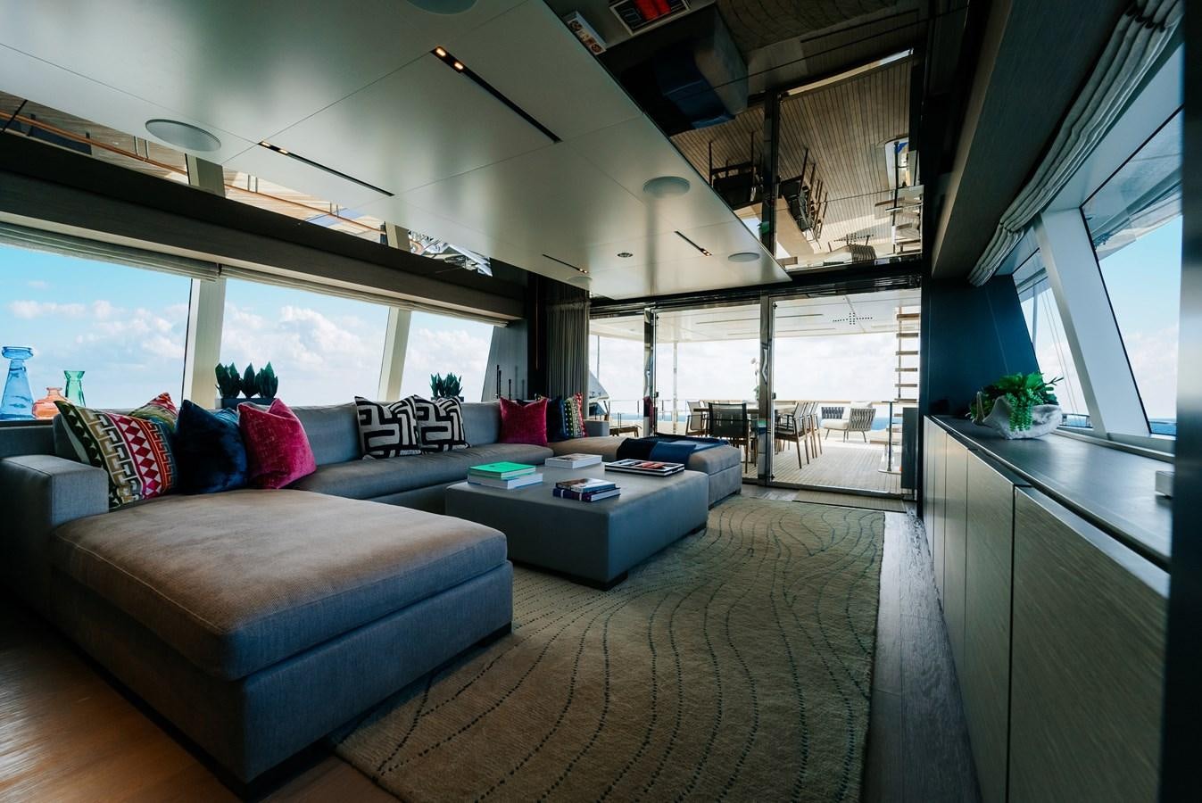 a living room with a large window aboard COFINA Yacht for Sale