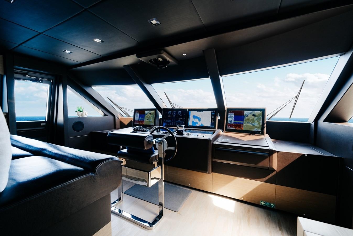 inside of a vehicle with a screen and a computer on the desk aboard COFINA Yacht for Sale