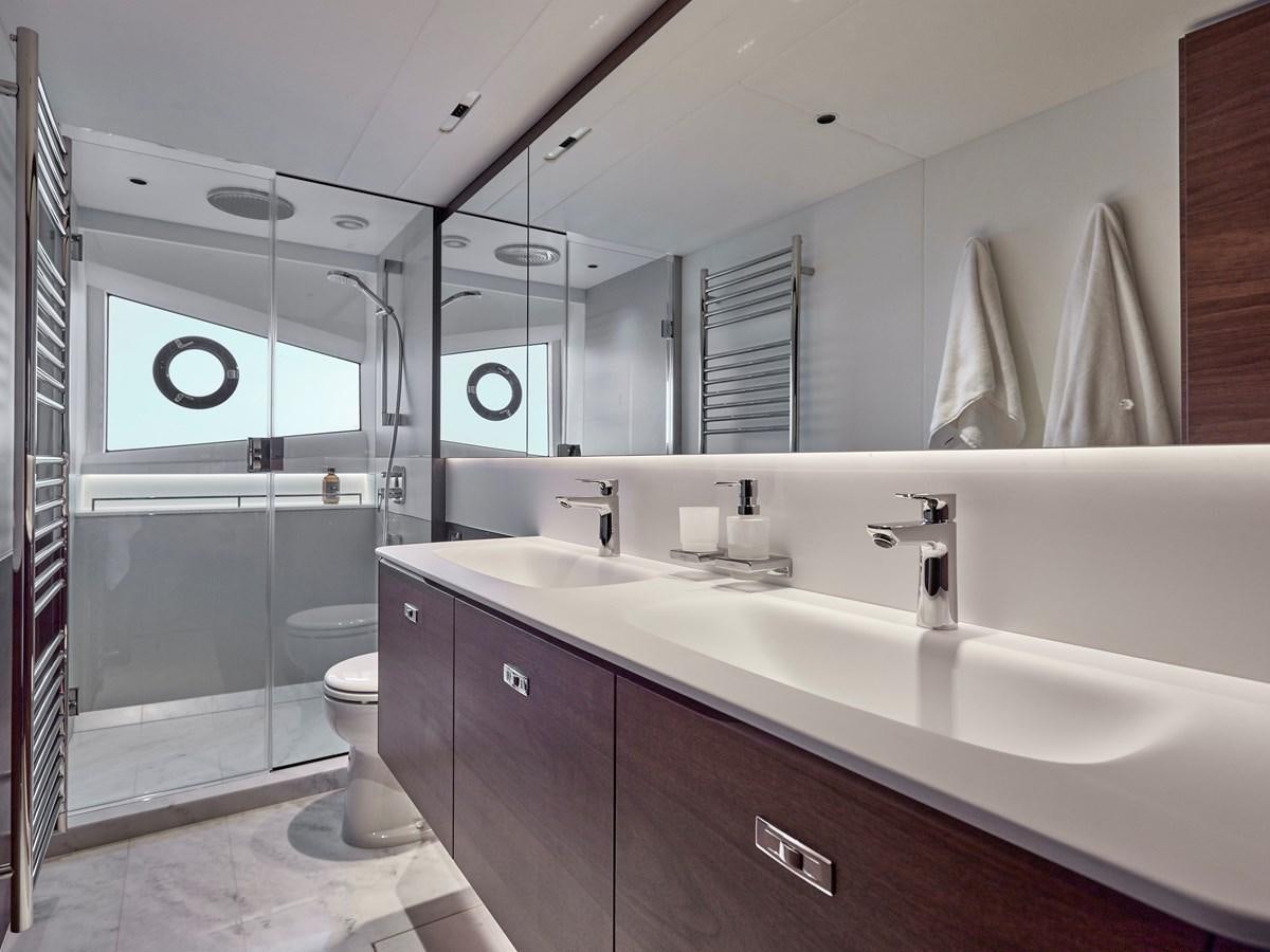 a bathroom with a large mirror aboard VENTURE Yacht for Sale